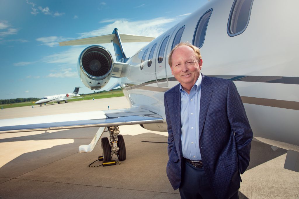 Charles (Chuck) Cox, Northern Jet Management beside a Bombarier Learjet